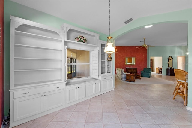 interior space with ceiling fan and built in features