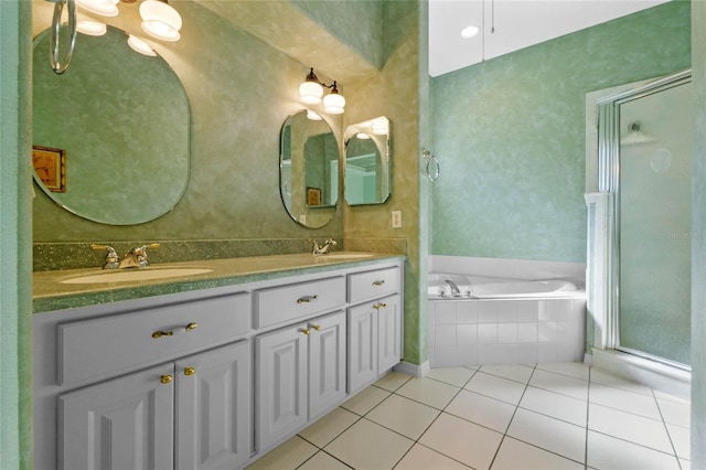 bathroom featuring shower with separate bathtub, vanity, and tile patterned flooring