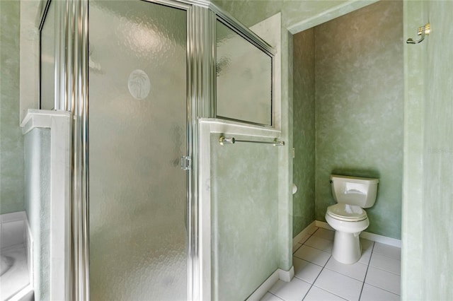 bathroom featuring tile patterned floors, a shower with door, and toilet