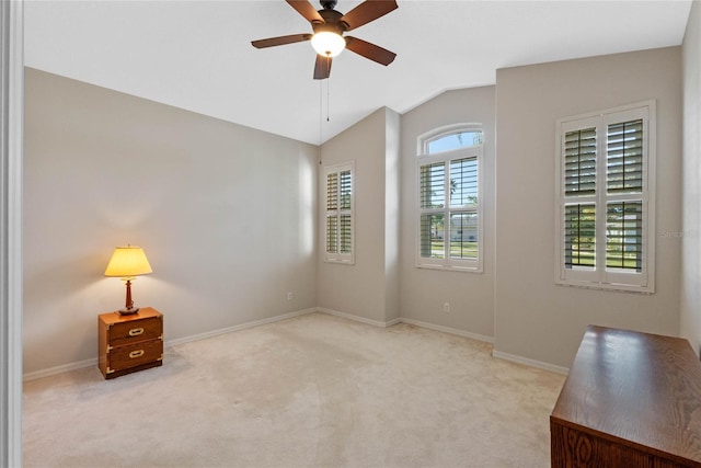 carpeted empty room with ceiling fan and lofted ceiling