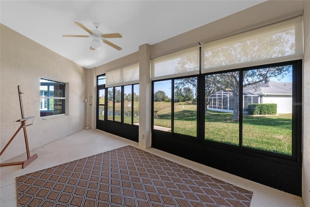 unfurnished sunroom featuring ceiling fan and lofted ceiling