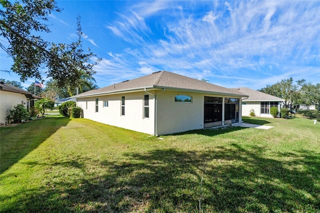 rear view of house with a yard