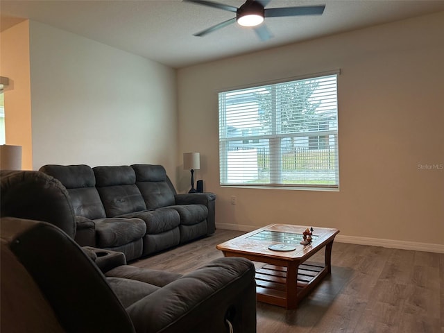 living room with dark hardwood / wood-style floors and ceiling fan