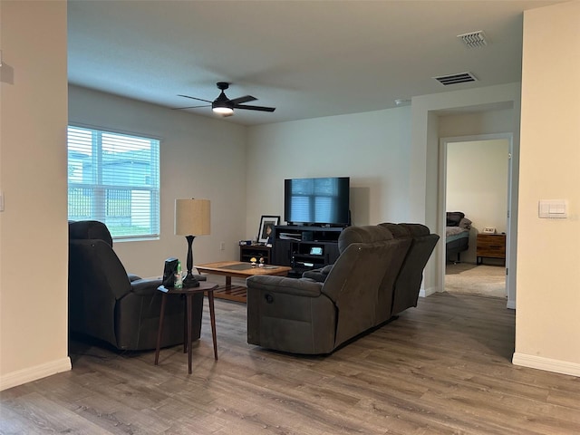 living room featuring ceiling fan and wood-type flooring