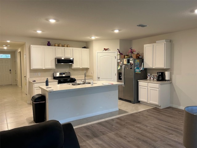 kitchen featuring white cabinetry, sink, light hardwood / wood-style flooring, a kitchen island with sink, and appliances with stainless steel finishes