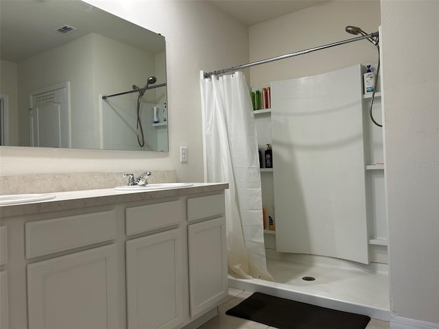 bathroom featuring vanity and curtained shower