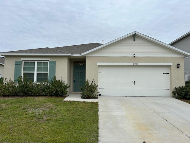 single story home featuring a garage and a front lawn