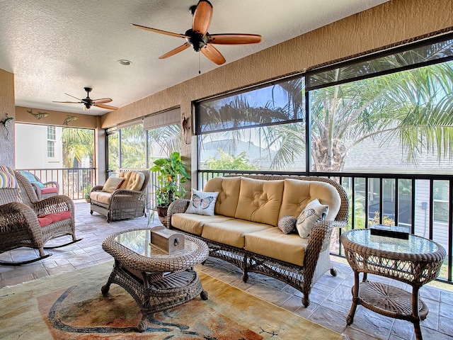 sunroom / solarium featuring ceiling fan