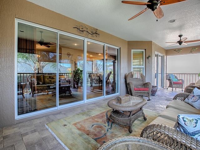 exterior space featuring an outdoor hangout area and ceiling fan