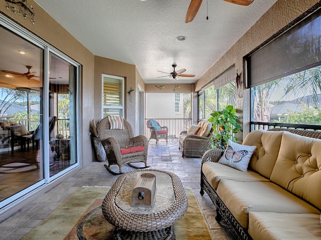 sunroom / solarium featuring ceiling fan