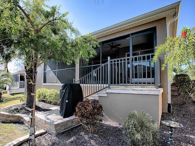 view of side of property featuring ceiling fan