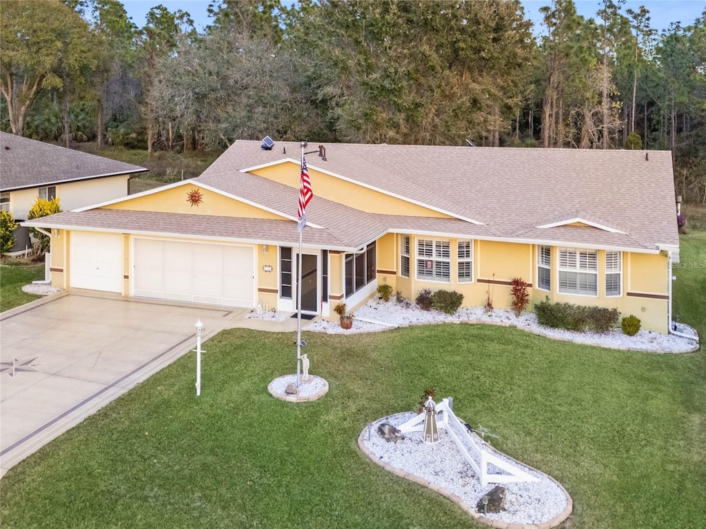 ranch-style home featuring a garage and a front yard