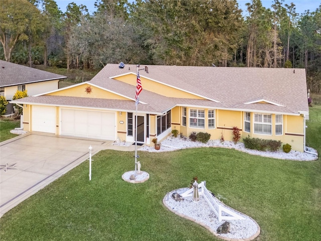 ranch-style home featuring a garage and a front yard