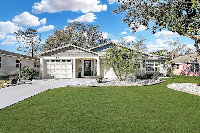 view of front of home with a front yard and a garage