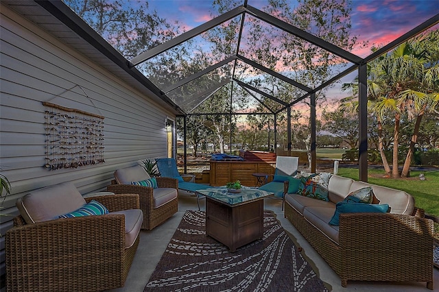 patio terrace at dusk featuring a lanai and an outdoor living space