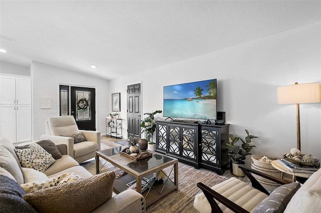 living room with lofted ceiling and hardwood / wood-style flooring