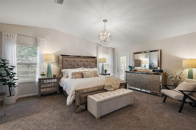 bedroom featuring lofted ceiling, dark carpet, and an inviting chandelier