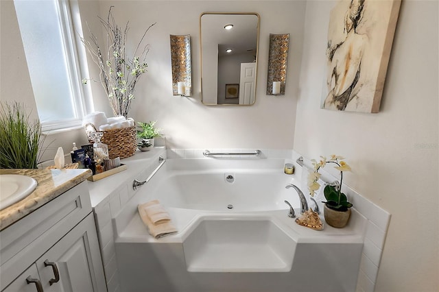 bathroom featuring vanity and a tub to relax in