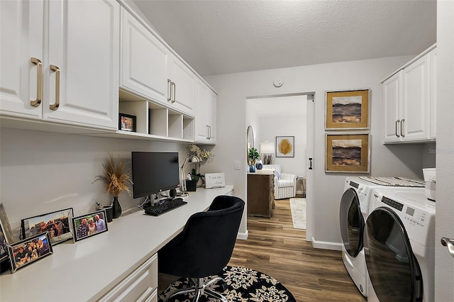 office featuring a textured ceiling, washing machine and dryer, built in desk, and dark hardwood / wood-style flooring