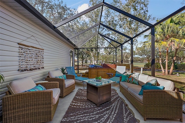 view of patio / terrace featuring a lanai, a hot tub, and an outdoor living space