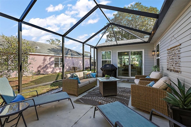 view of patio with grilling area, an outdoor hangout area, and glass enclosure