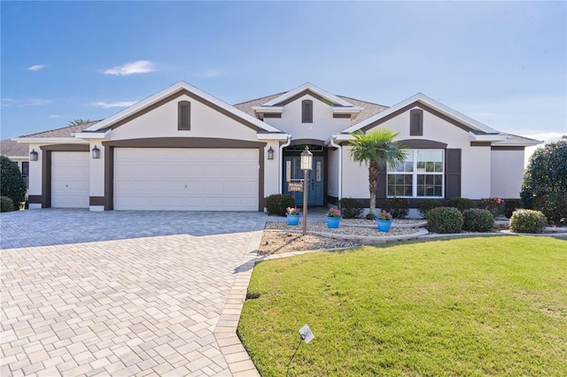 view of front of home with a front lawn and a garage