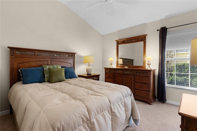 bedroom featuring ceiling fan, vaulted ceiling, and light carpet