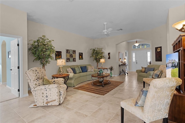 tiled living room featuring ceiling fan