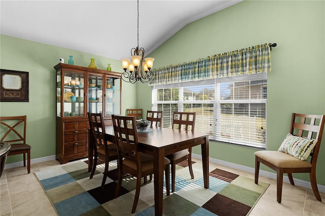 tiled dining room featuring a notable chandelier and lofted ceiling