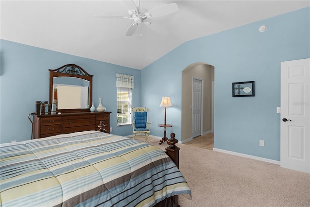 carpeted bedroom with ceiling fan and vaulted ceiling