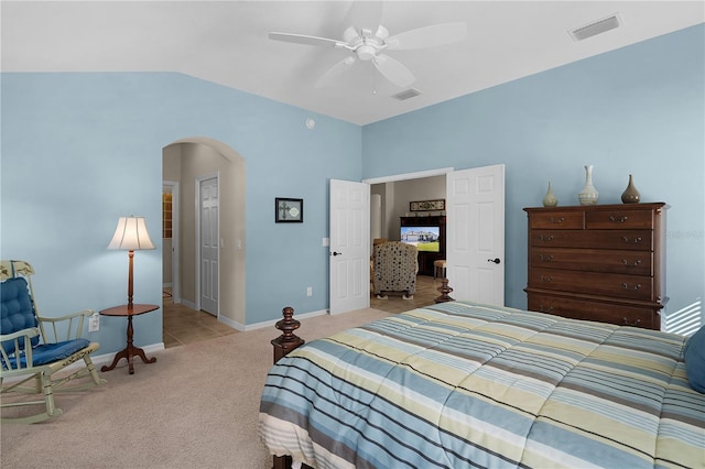 carpeted bedroom featuring ceiling fan, a closet, and vaulted ceiling