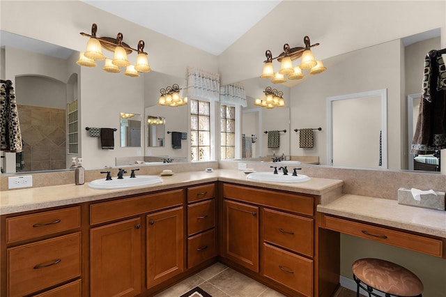 bathroom featuring a shower, tile patterned flooring, vaulted ceiling, and vanity