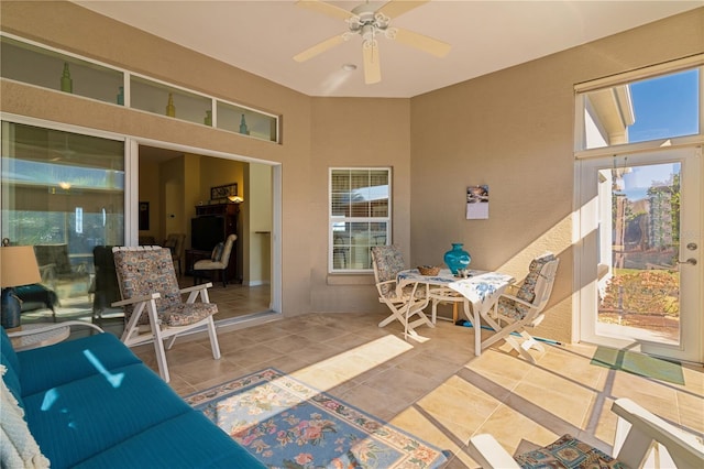 sunroom / solarium featuring ceiling fan