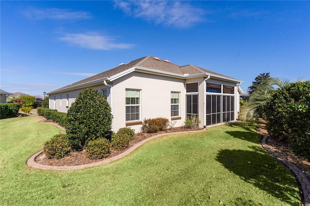 view of property exterior with a yard and a sunroom