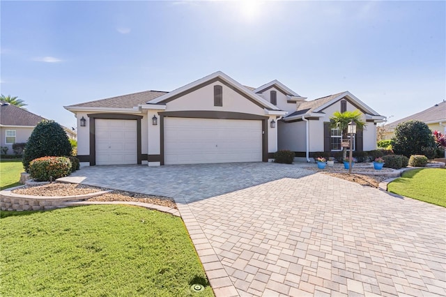 single story home featuring a garage and a front lawn