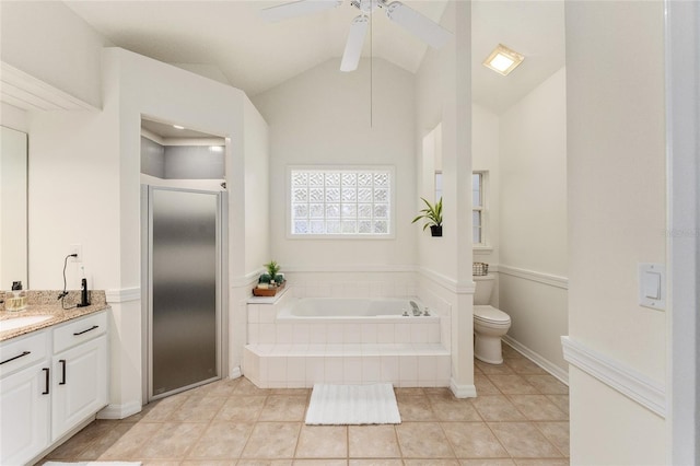 full bathroom featuring vaulted ceiling with beams, tile patterned flooring, shower with separate bathtub, toilet, and vanity