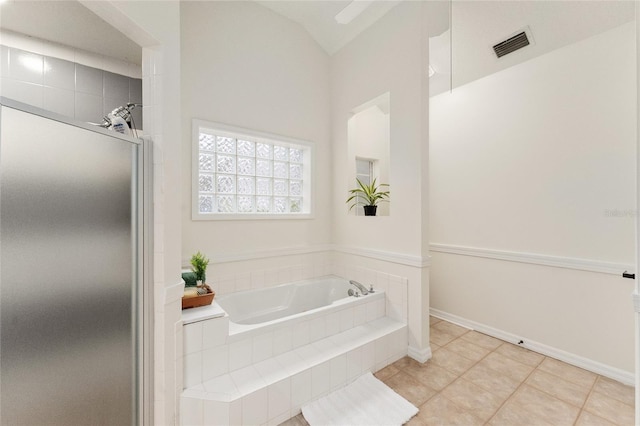 bathroom with tile patterned floors, plus walk in shower, and vaulted ceiling