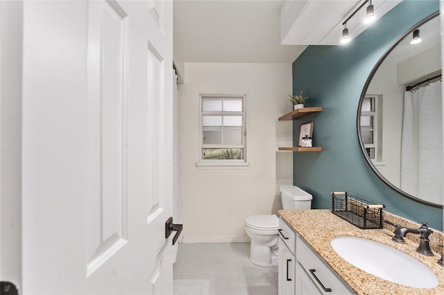 bathroom with tile patterned floors, vanity, and toilet