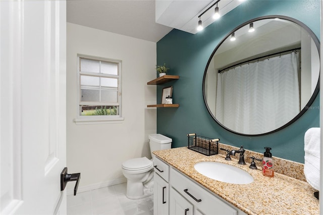 bathroom with tile patterned flooring, vanity, toilet, and track lighting