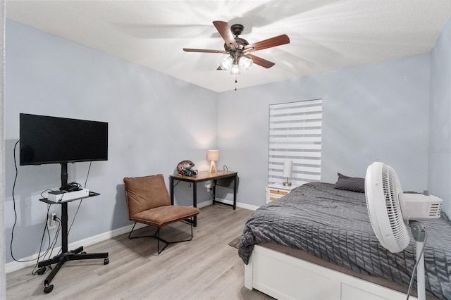 bedroom with ceiling fan and light hardwood / wood-style flooring