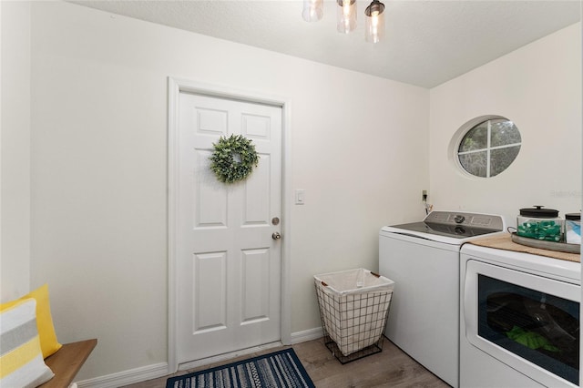 washroom featuring washer and clothes dryer and light wood-type flooring