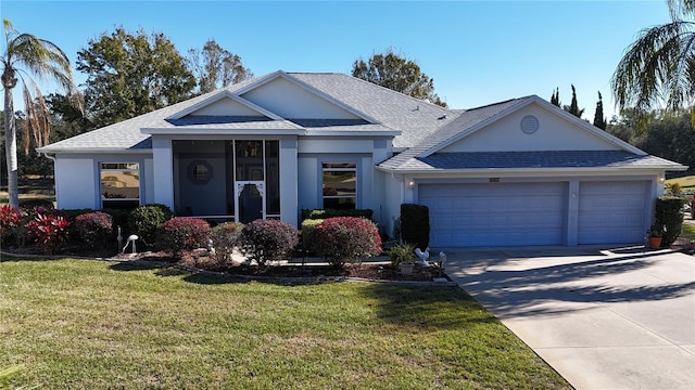 ranch-style home featuring a garage and a front lawn