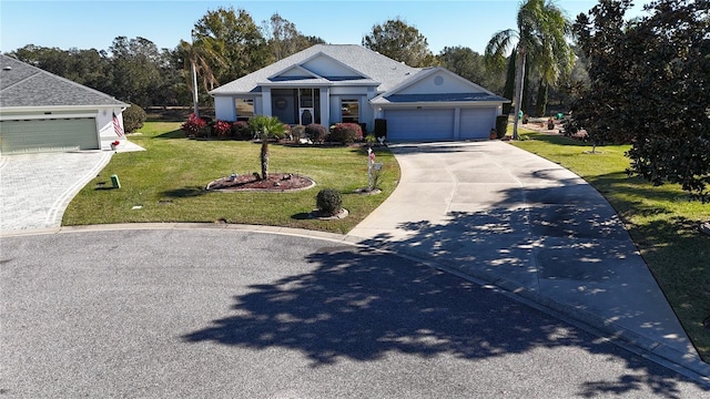 view of front of house with a front yard and a garage