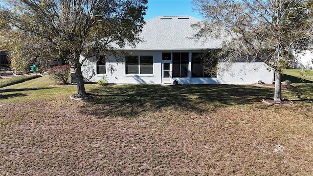 view of front facade featuring a sunroom and a front lawn