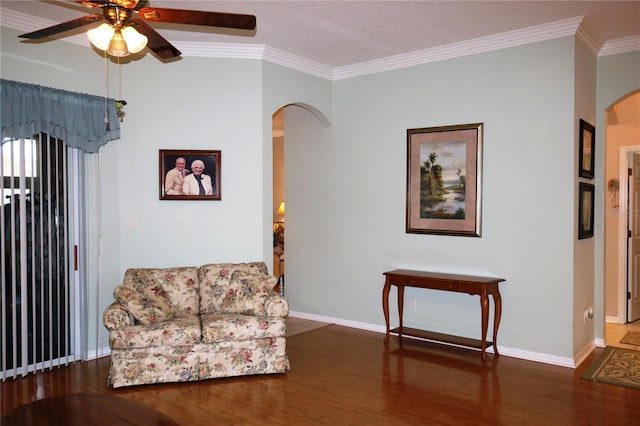 sitting room with ceiling fan, dark hardwood / wood-style flooring, and ornamental molding