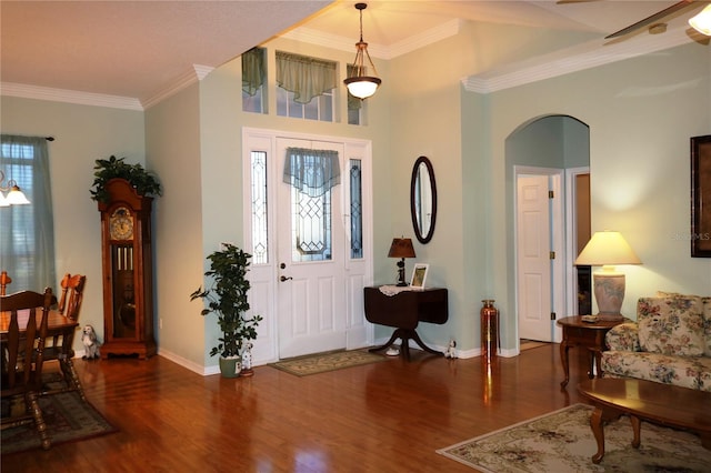 entryway with dark hardwood / wood-style floors and ornamental molding