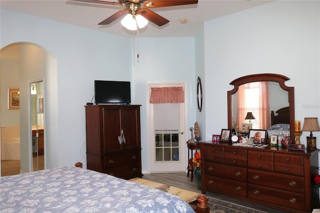 bedroom with ceiling fan, light wood-type flooring, and ensuite bath