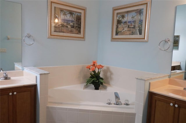 bathroom featuring vanity and tiled bath