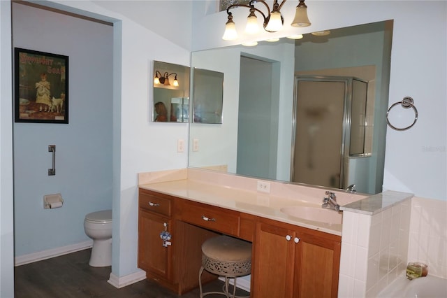 full bathroom featuring plus walk in shower, hardwood / wood-style floors, vanity, and toilet