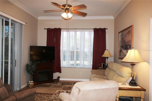 living room with ceiling fan and ornamental molding